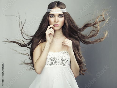 Photo: Portrait of young beautiful woman with long flowing hair Portrait of young beautiful woman with long flowing hair