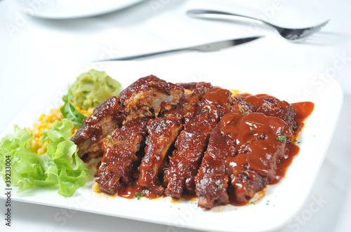 Photo: Closeup of barbecued pork ribs and vegetables Closeup of barbecued pork ribs and vegetables
