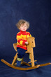 little child on a rocking horse little child on a rocking horse