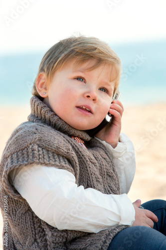 Photo: Baby girl talking on mobile phone. Baby girl talking on mobile phone.