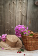 basket of flowers and a straw hat