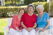 Portrait of three friends smiling in a park