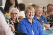 Senior women laughing at a luncheon