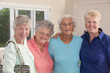 Portrait of four senior female friends smiling together
