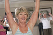 Senior exercise class working with dumbbells