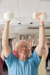 Senior exercise class doing arm stretches