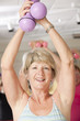 Senior exercise class working with dumbbells