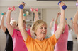 Seniors exercising with dumbbells in a health club