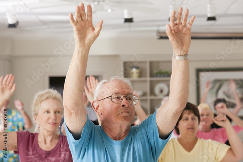 Photo: Seniors exercising in a health club Seniors exercising in a health club