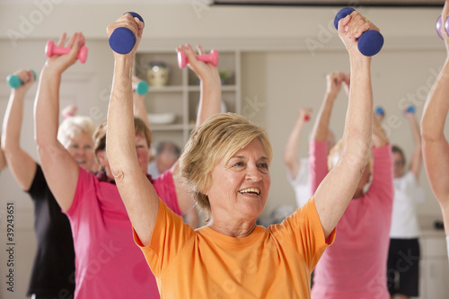Photo: Seniors exercising with dumbbells in a health club Seniors exercising with dumbbells in a health club