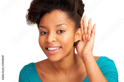 Photo: Amused girl cupping ear and listening Amused girl cupping ear and listening