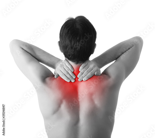 Photo: Rear view of a young man holding his neck in pain, isolated on w Rear view of a young man holding his neck in pain, isolated on w