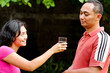 ethnic young woman offer pure mineral water to male friend