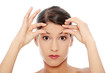 Woman checking her wrinkles on her forehead