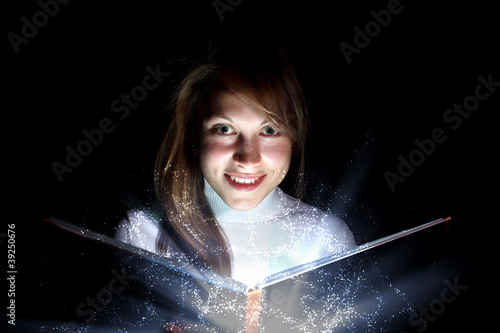 Illustration: Young woman reading a magic book Young woman reading a magic book