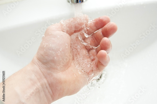 Photo: Washing of hands under the crane with water Washing of hands under the crane with water