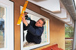 carpenter mounting a new window