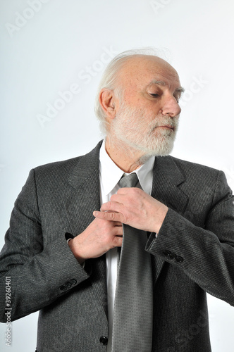 Photo: a man fixes his tie a man fixes his tie