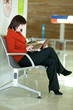Photo: Beautiful female tourist in the airport with laptop, waiting for Beautiful female tourist in the airport with laptop, waiting for