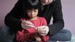 Girl Getting Her Fingernails Trimmed By Mother