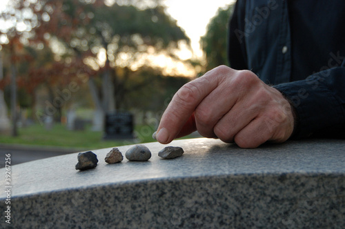 Photo: Leaving pebbles on headstone Leaving pebbles on headstone