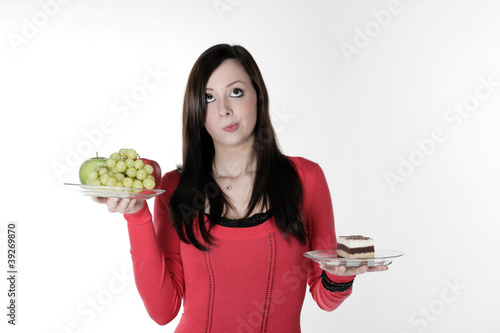 Photo: A pretty girl with fruit and cake on her hand A pretty girl with fruit and cake on her hand