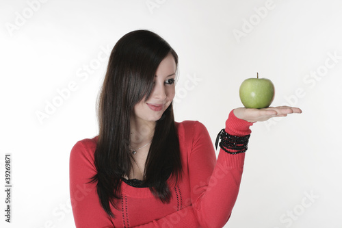 Photo: A pretty girl with an apple in her hand A pretty girl with an apple in her hand