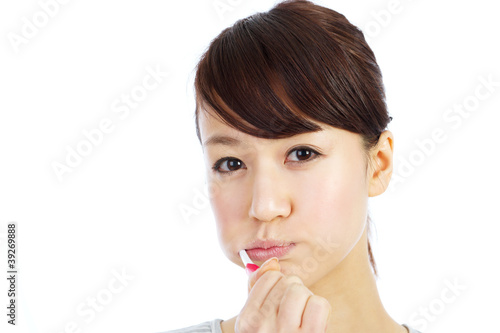 Photo: Beautiful young woman brushing her teeth Beautiful young woman brushing her teeth