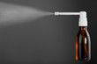 Bottle of throat spray isolated on gray background Bottle of throat spray isolated on gray background