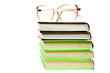 Stack of books with glasses isolated