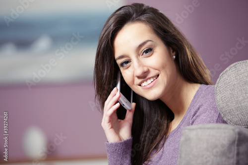 Photo: portrait of young smiling woman on phone portrait of young smiling woman on phone