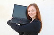 Pretty redhead woman holding a laptop