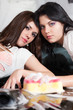 Two girlfriends caress each other in a soapsuds