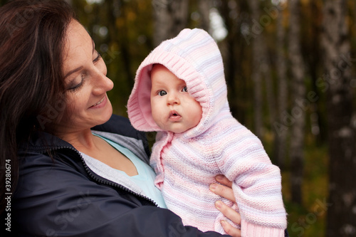 Photo: Happy woman with little baby girl Happy woman with little baby girl