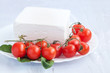 Cherry tomatoes and bulgarian white cheese in a plate Cherry tomatoes and bulgarian white cheese in a plate