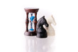 Two chess horses with sand-clock