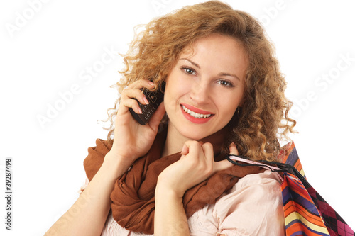 Photo: Portrait of an attractive young woman with shopping bags Portrait of an attractive young woman with shopping bags