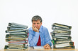 man studies folder with files at his desk in the office