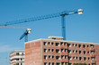 building under construction and cranes.