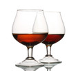 Two glasses of cognac isolated on white