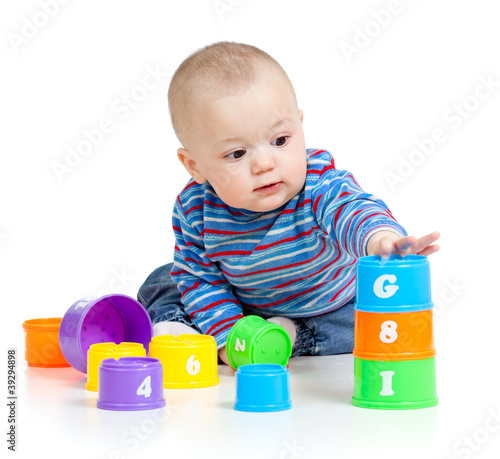 Photo: baby is playing with educational toys, isolated over white baby is playing with educational toys, isolated over white