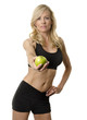 Woman on diet in exercising attire holding apple