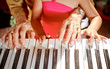 hands of old woman and child playing piano hands of old woman and child playing piano