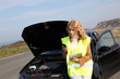 Woman standing by broken down car Woman standing by broken down car