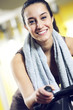 A young woman riding an exercise bike