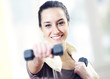 dumbbell in hand of working out young smiling female
