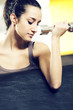 portrait of  young woman lifting free weights