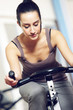 A young woman riding an exercise bike