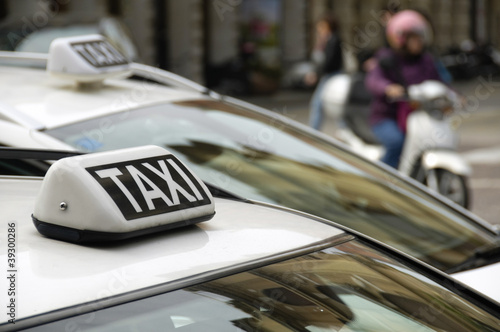 Photo: Taxi sign on an urban cab Taxi sign on an urban cab