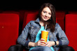 Photo: Young girl in cinema watching movie Young girl in cinema watching movie